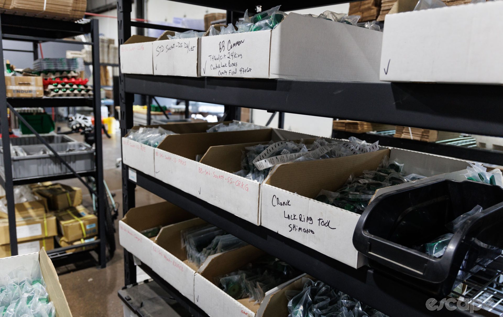 The photo shows shelves of bottom bracket sockets in Abbey Bike Tools' warehouse.