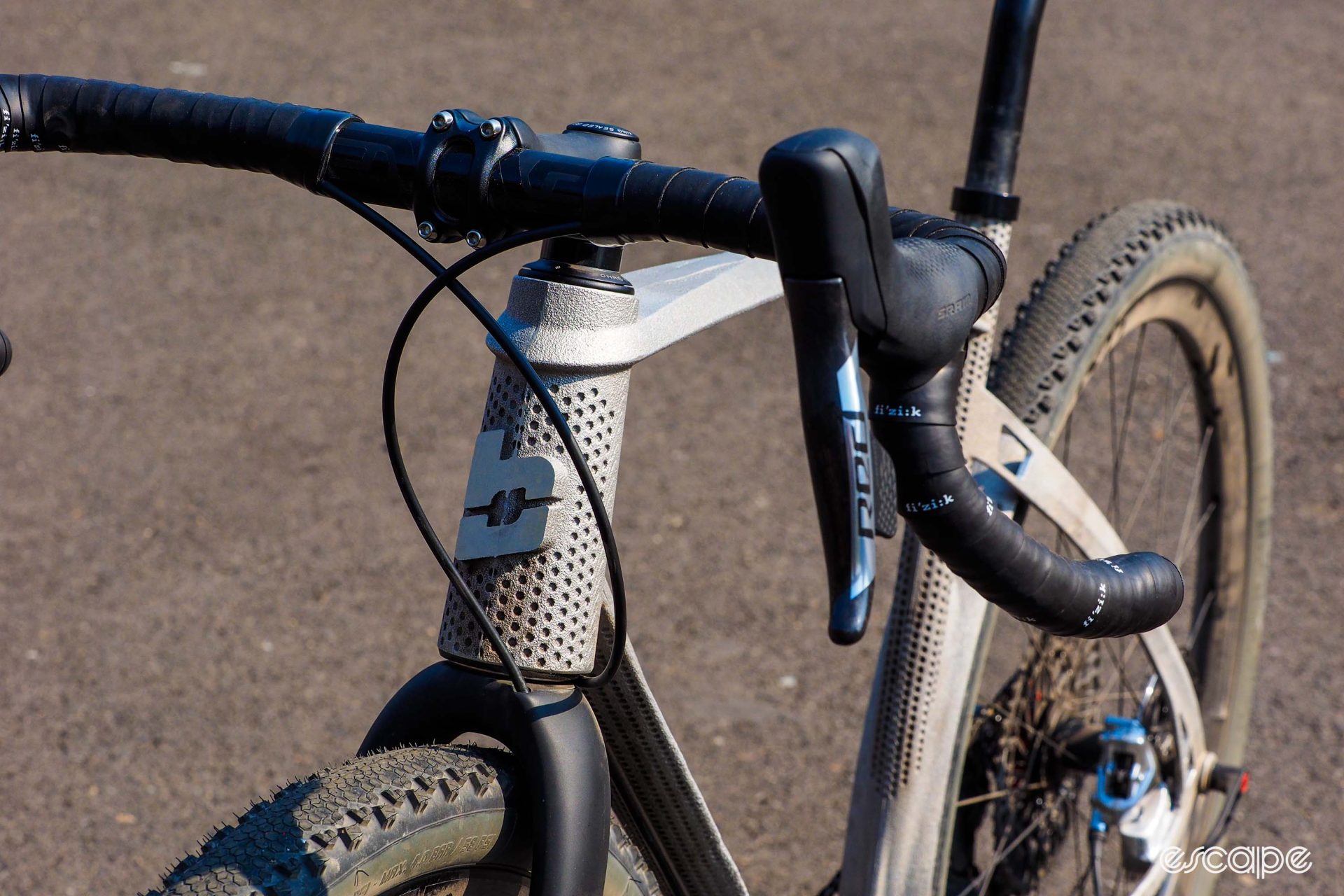 Detail shot of headtube area, showing dotted detailing and protruding logo. 