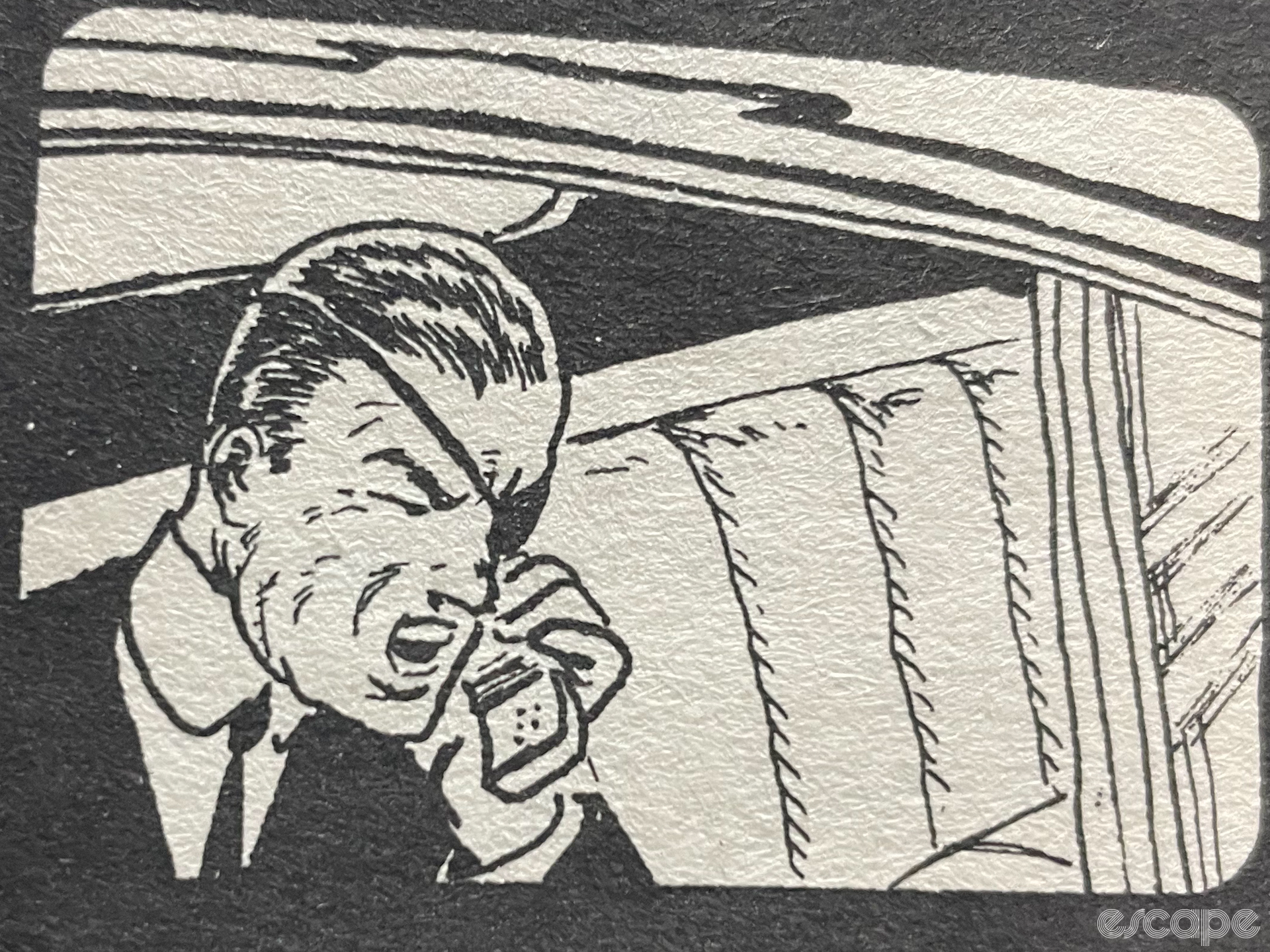 A photo of an illustration in a book of a man with an eyepatch yellowing into a mobile phone from within a limo.