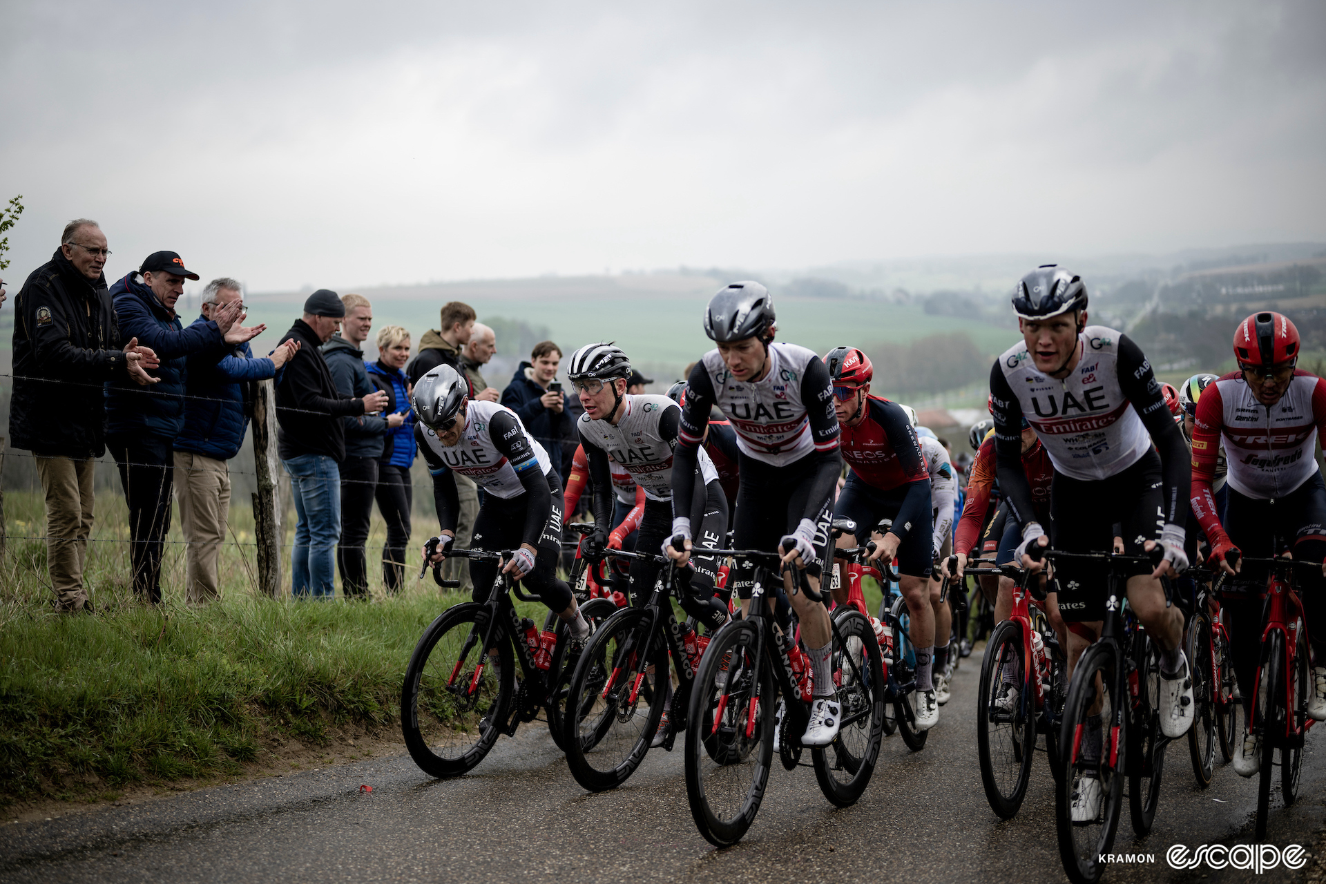 UAE Team Emirates rode strongly for Pogačar at the spring classics. Here, the whole team is spread out across the front of the pack on a climb at Amstel Gold Race, on a cold, grey, wet day.