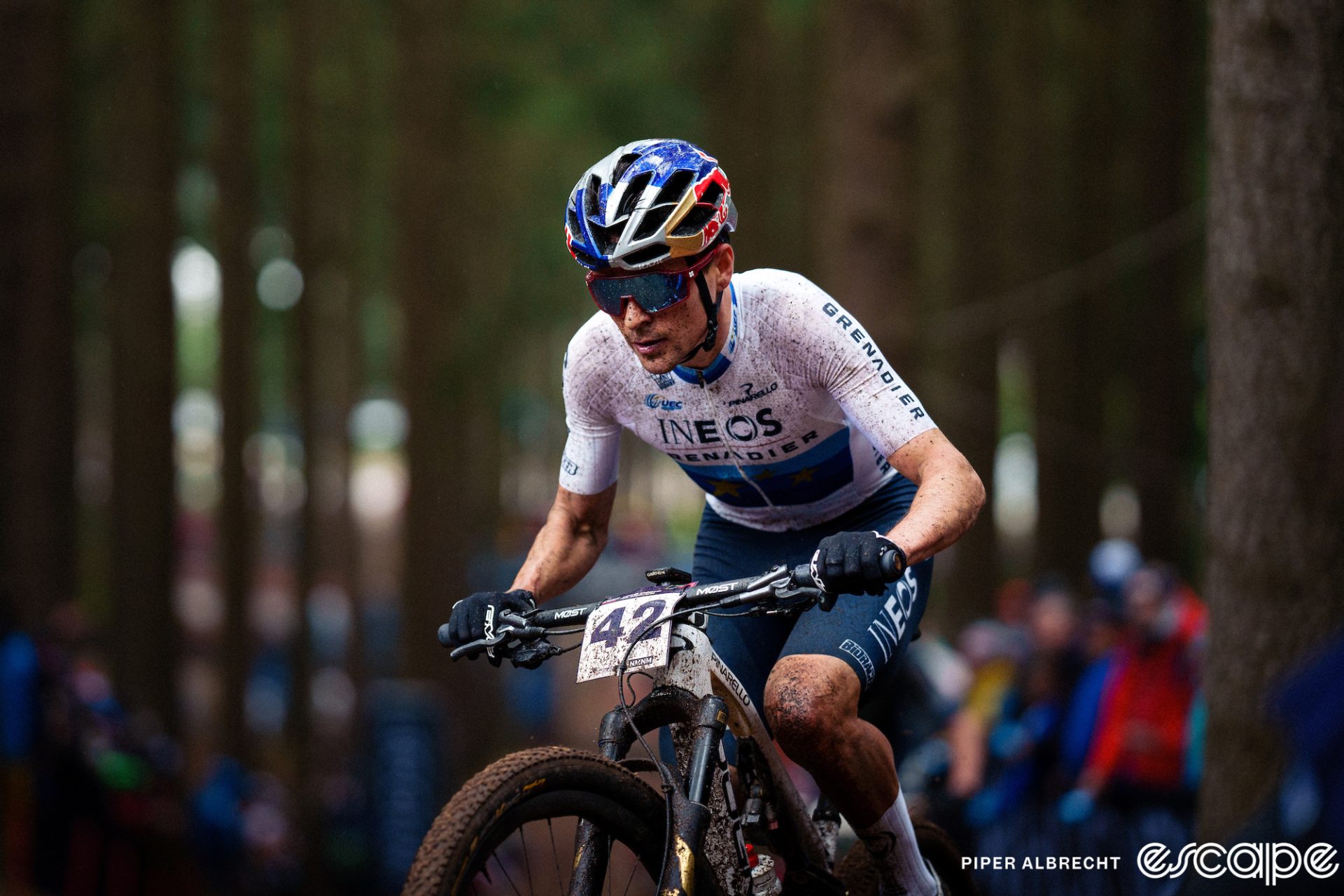 Tom Pidcock, wearing the jersey of European Champion, grinds up a climb at Nove Mesto, his only World Cup of 2023, where he won.