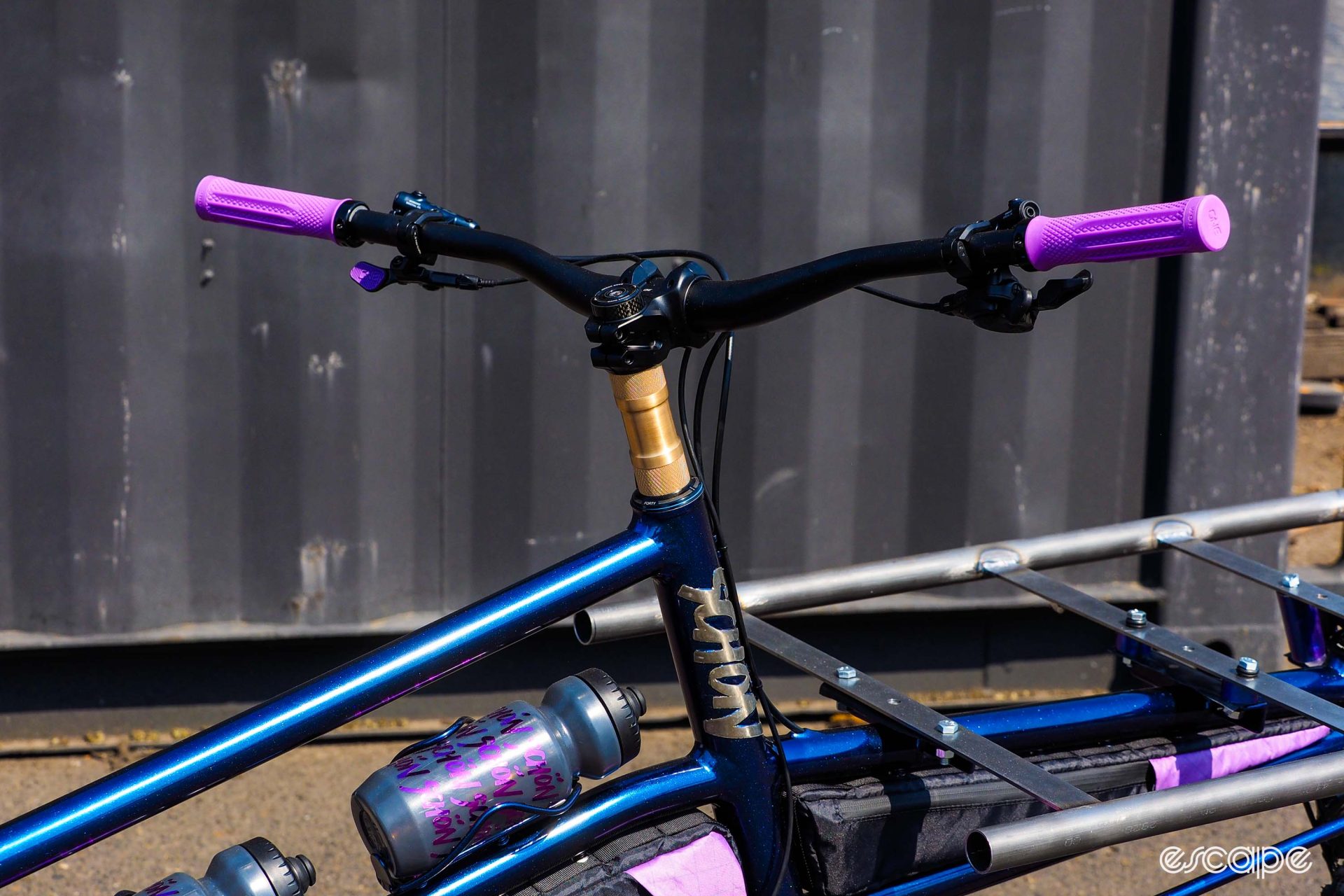 Detail shot of headtube area, showing a tall, visually striking brass spacer beneath the handlebar and stem.