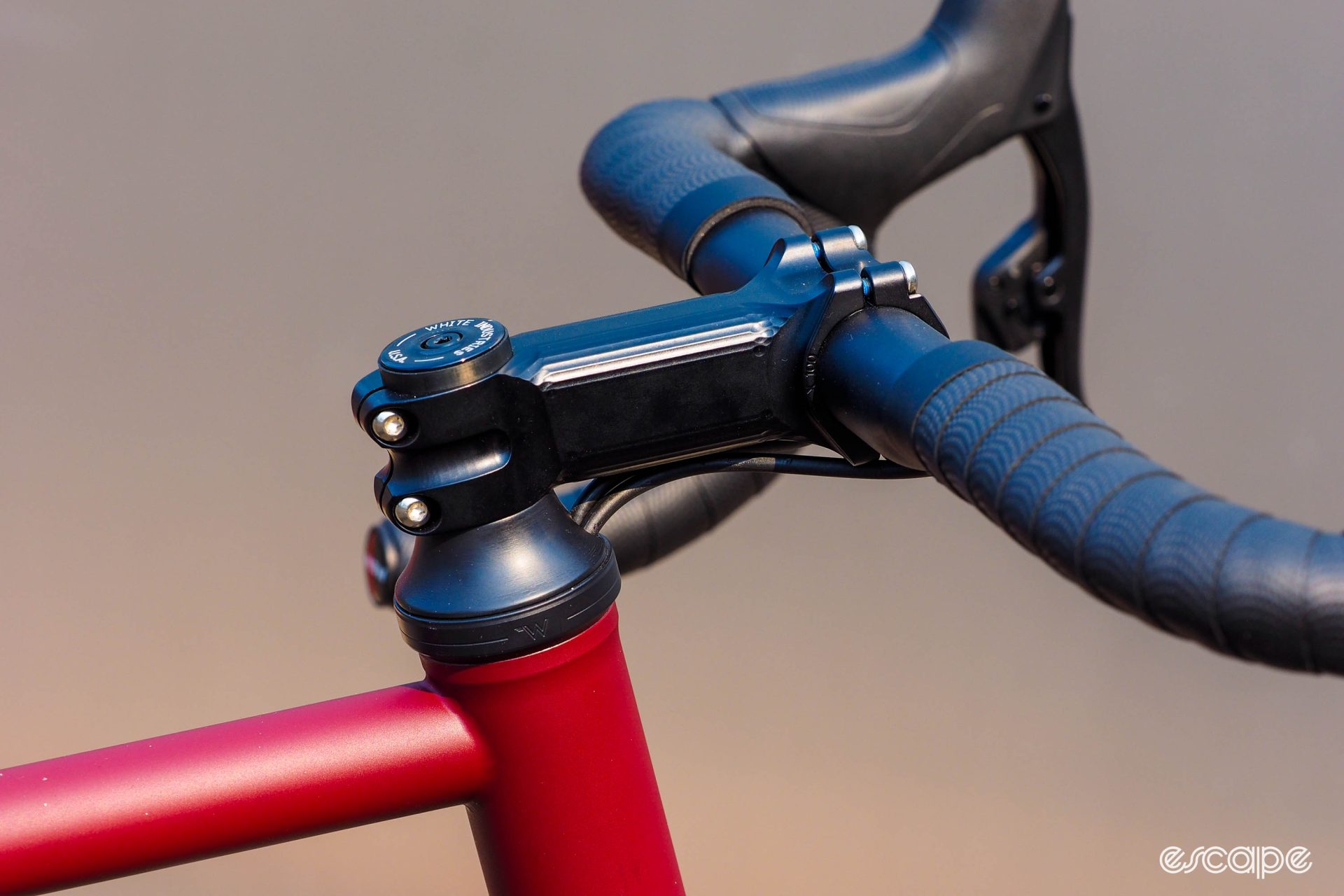 Detail shot of headtube and headset, with hydraulic lines routed into the top of the headset. 
