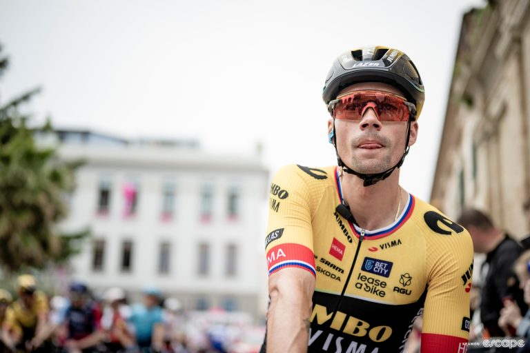 Primoz Roglic stands over his bike on the start line of stage 3 of the 2023 Giro d'Italia.