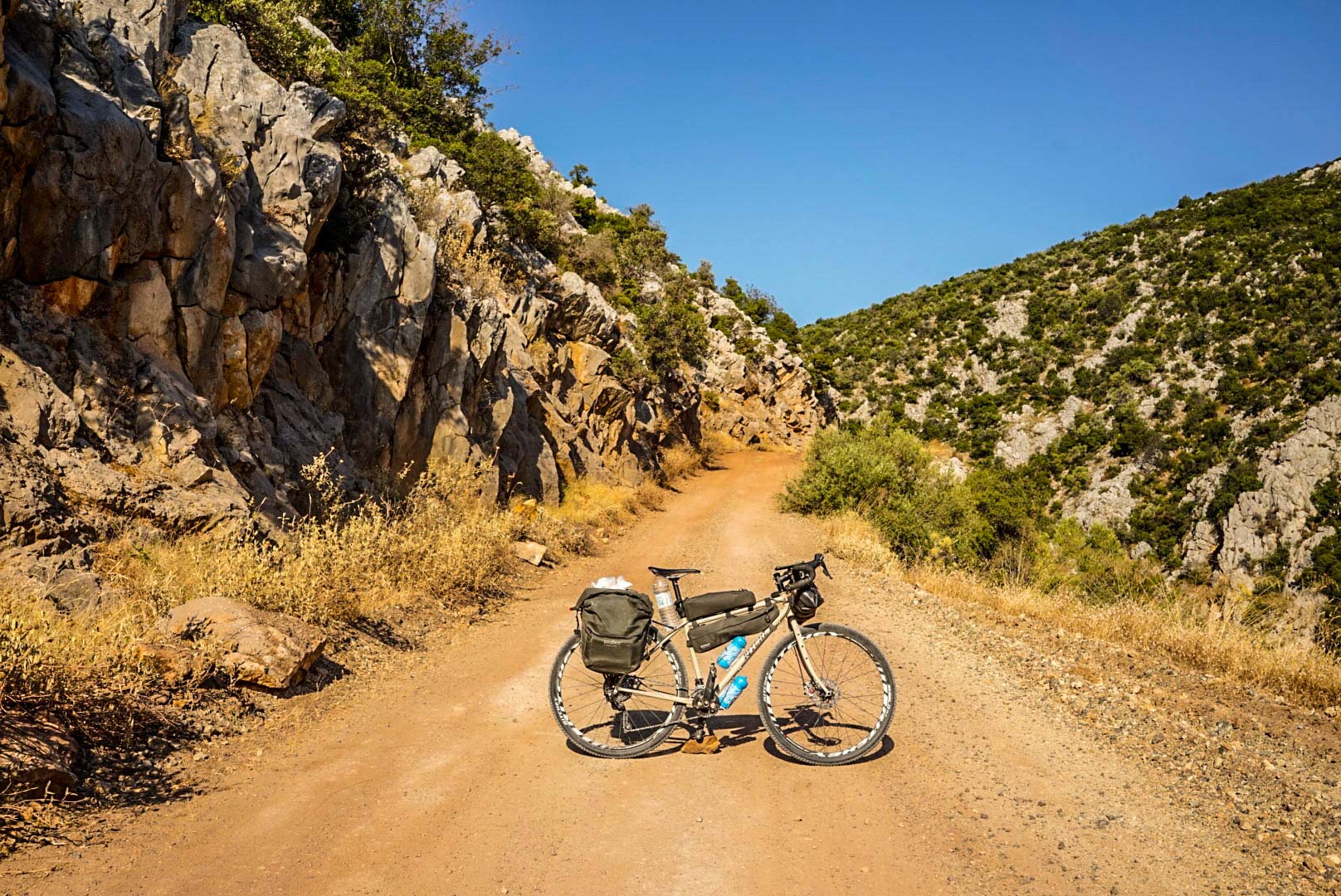 Lazzarin's bike in profile on a mountainous, rocky road.