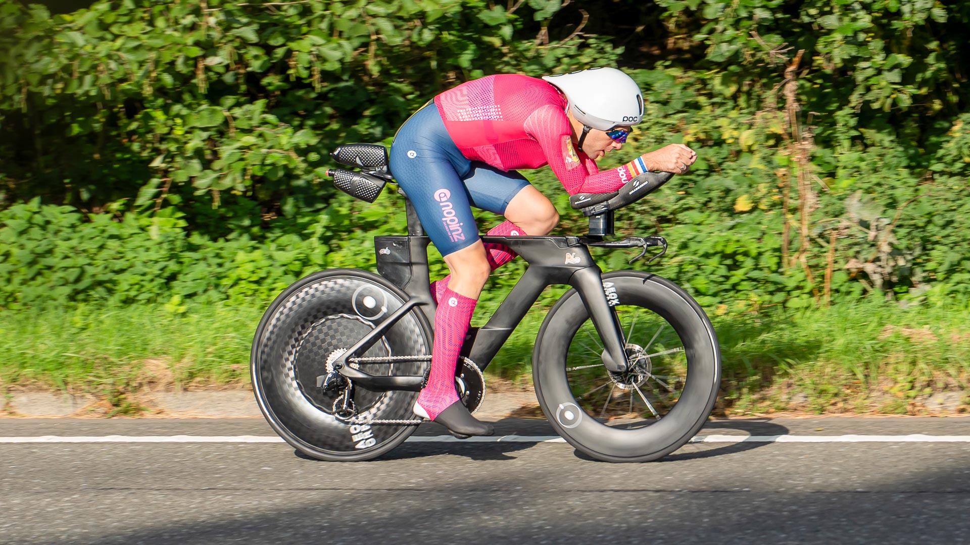 The photo shows Alex Dowsett in a time trial position