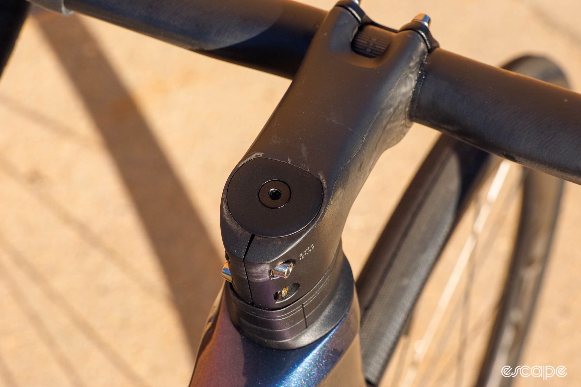 The stem on the 2024 Giant Defy Advanced SL features a D-shaped clamp section to fit the steerer tube; even the top cap has a D shape to it.