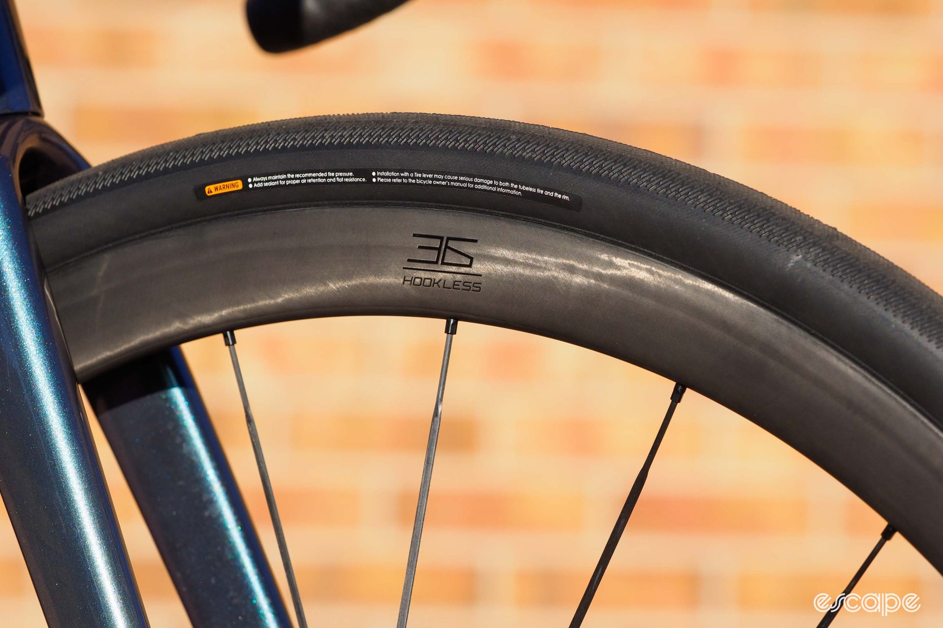 A closeup of the Cadex wheels, showing a logo for hookless rim sections.