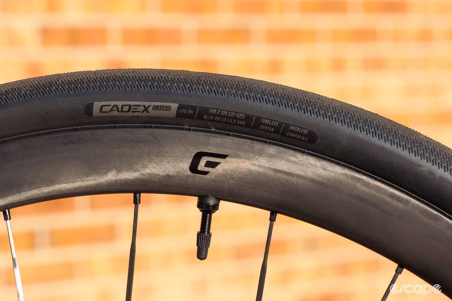 The Cadex tires from the side, showing a low-profile tread with almost zero height.