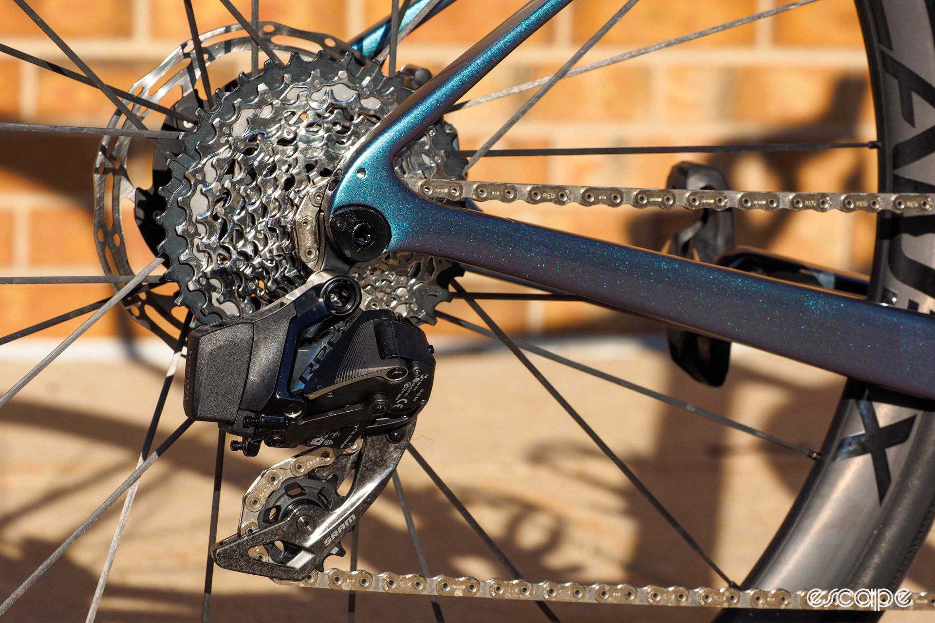 The rear derailleur, cassette, and chain on the 2024 Giant Defy Advanced SL 0. There's a SRAM Red AXS eTap rear derailleur, but Giant uses a Force-level cassette for a wider gear range than Red allows and, of course, SRAM's Flattop 12-speed road chain. There is no SRAM UDH derailleur hanger system on the new Defy series.