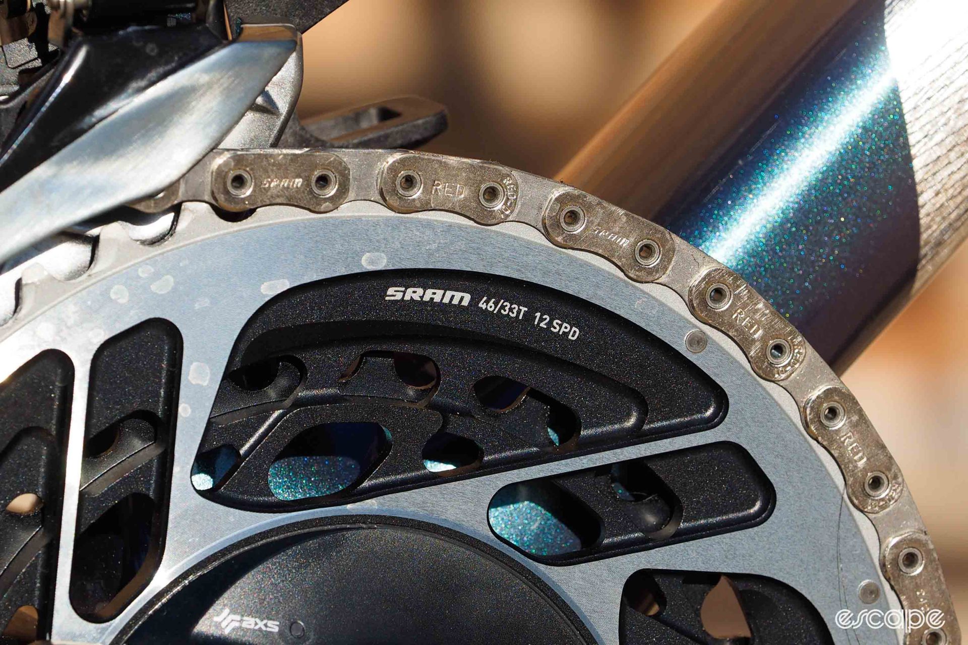 A closeup of the chainrings, showing the 33/46T gearing and Red Flattop chain.