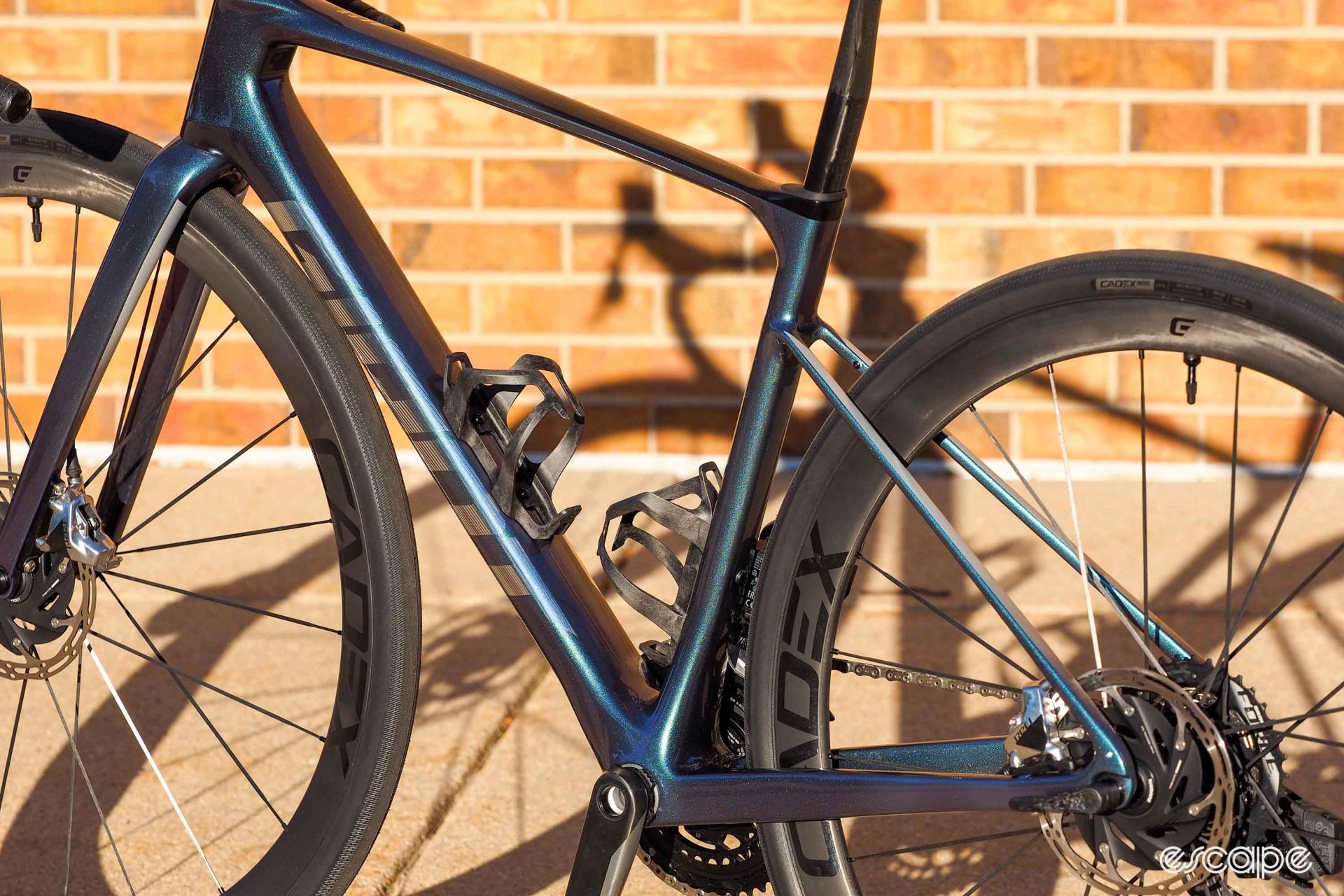 The 2024 Giant Defy Advanced SL in rear-quarter profile, showing the variation in tube size from top to bottom in the bike; tubes are notably beefier and more square at the bottom for stiffness, and thinner and rounder up top for compliance.