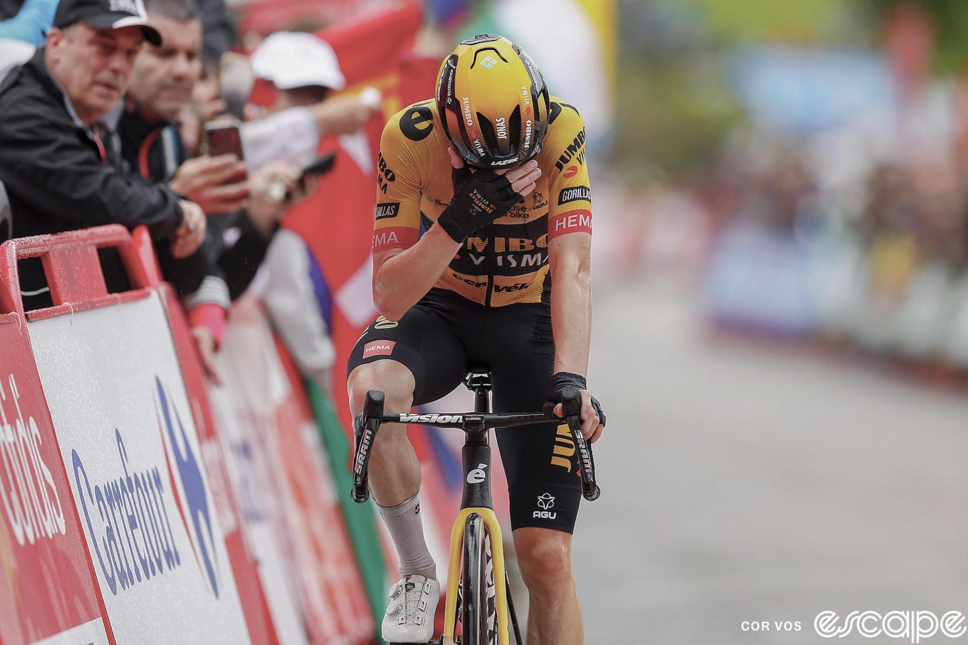 Jonas Vingegaard wins stage 16 of the 2023 Vuelta a España. He crosses the line alone, hand over his eyes, likely thinking about friend and teammate Nathan van Hooydonck, in the hospital after a car crash that morning.