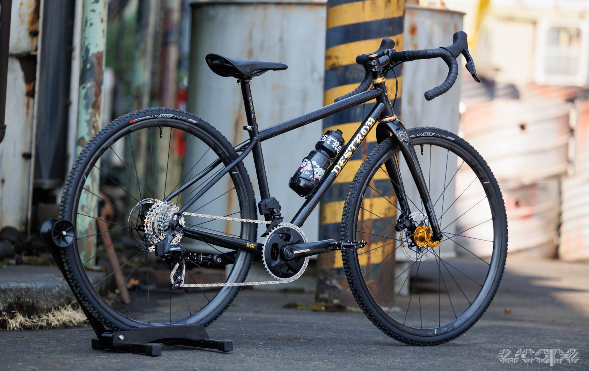 A side-on view of a black and gold bicycle from Destroy. 