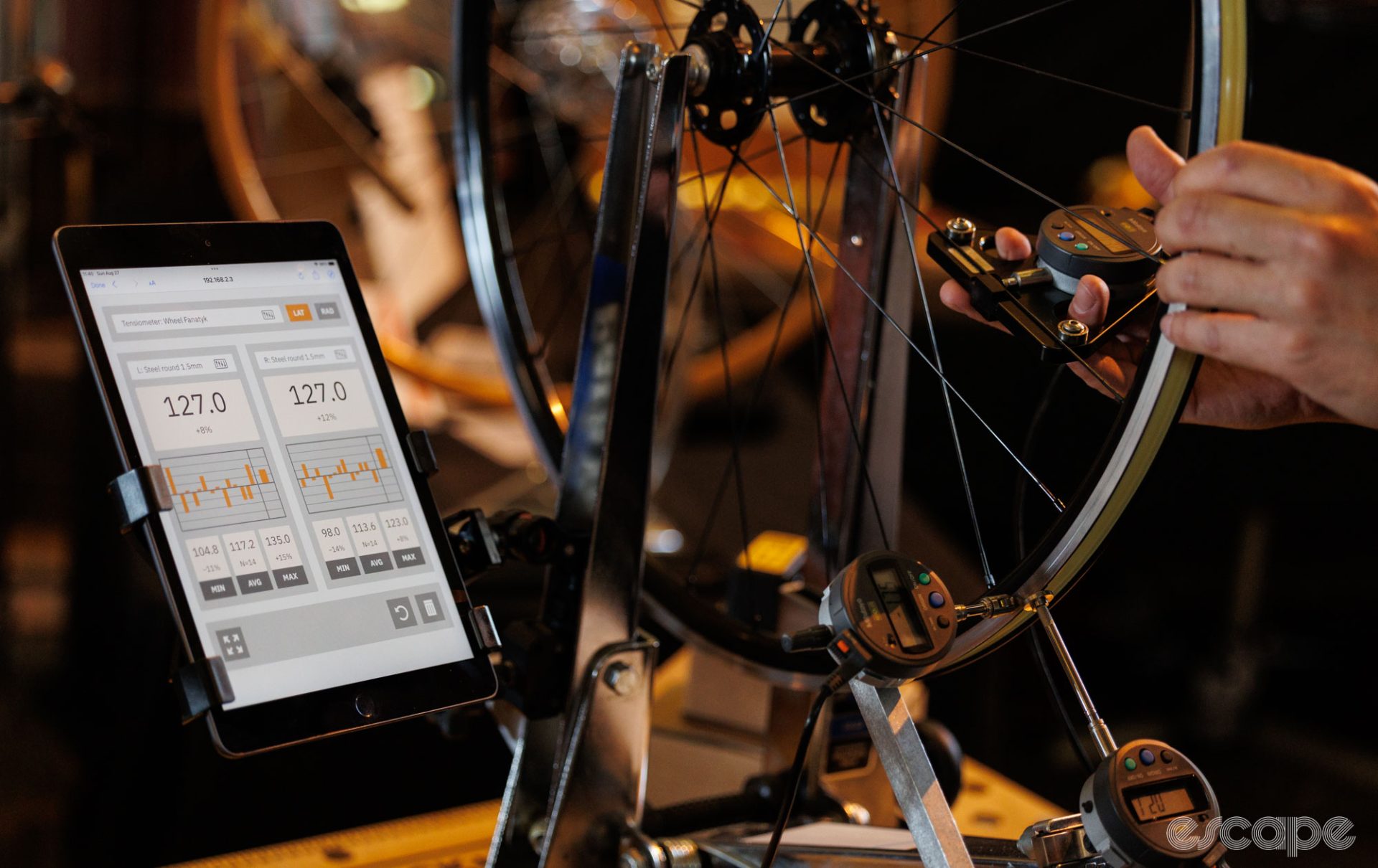 Spoke tension being measured by a digital tensionmeter and displayed on an ipad. 