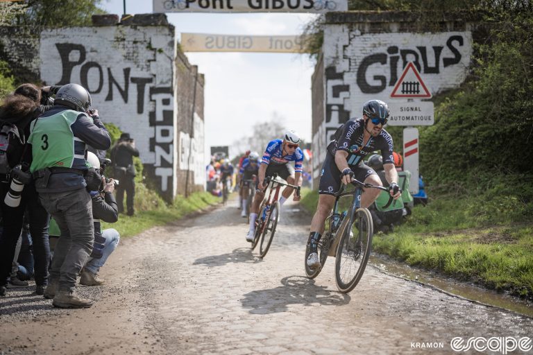 John Degenkolb leads Mathieu van der Poel past the famous "Pont Gibus" rail bridge in the 2023 Paris-Roubaix.