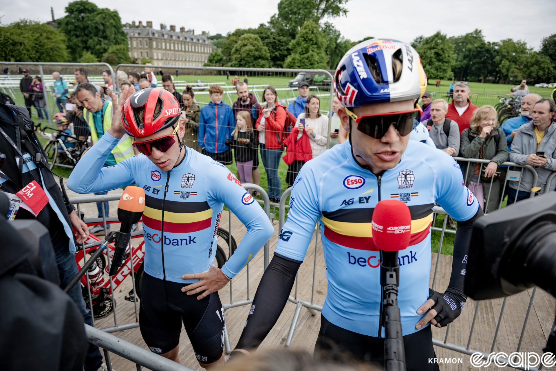 Remco Evenepoel and Wout van Aert speak with assembled media at the start of the 2023 men's World Championship road race in Glasgow, Scotland.