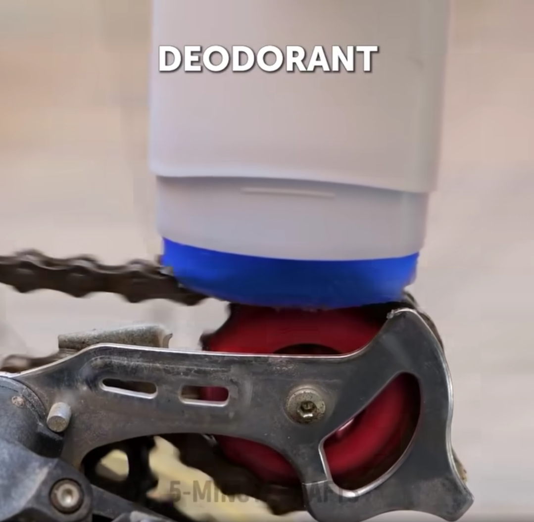 Someone using a deodorant stick as a chain lubricant. 