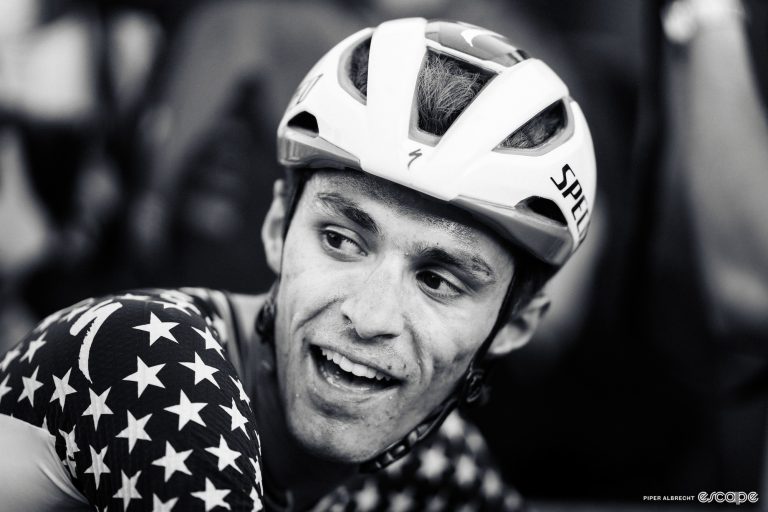 American mountain bike racer Chris Blevins, shown in close-up profile in black-and-white. He's shown looking over his right shoulder, and is wearing the US National Champion's jersey.