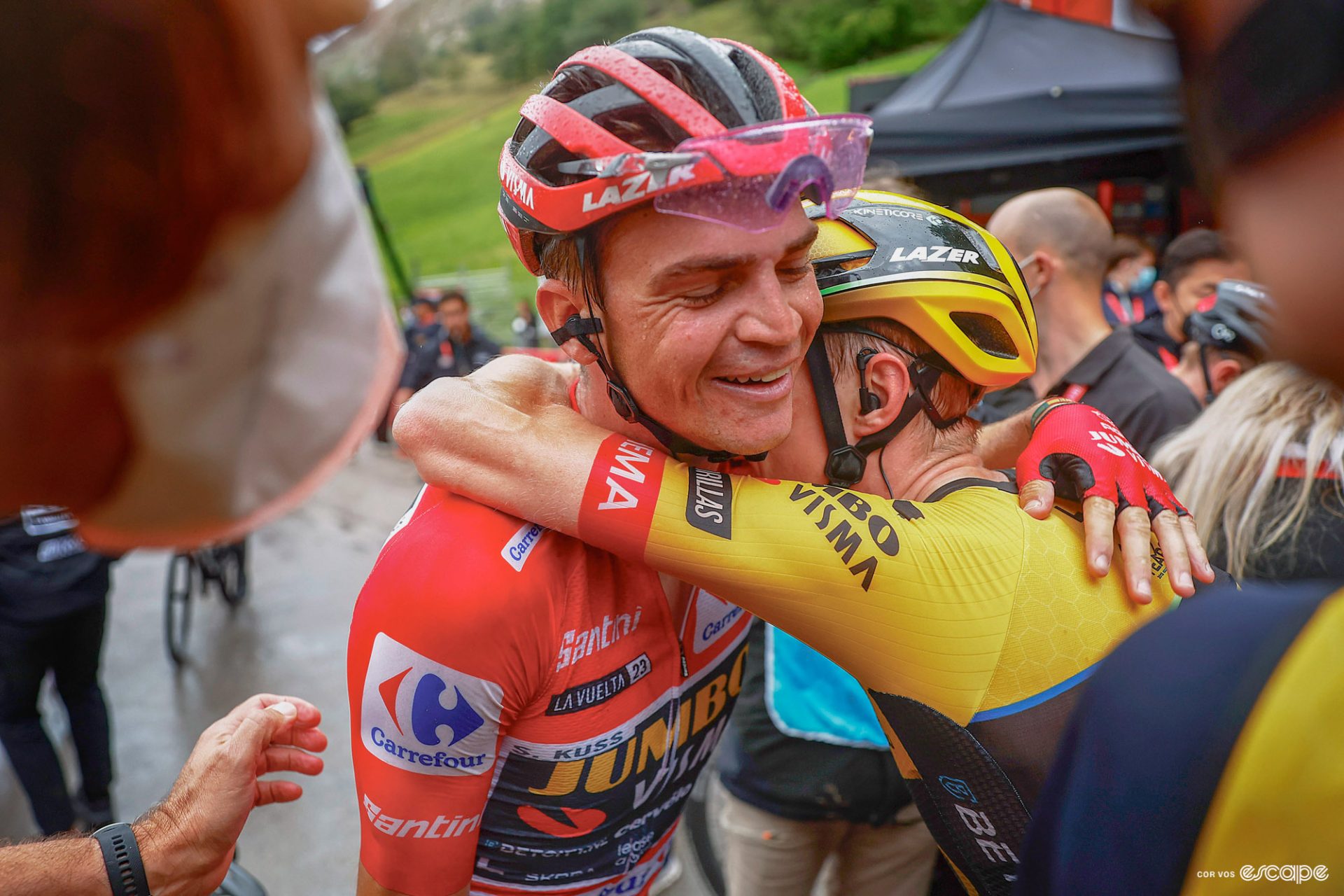 Sepp Kuss in the Vuelta's red leader's jersey embraces an emotional Jonas Vingegaard.