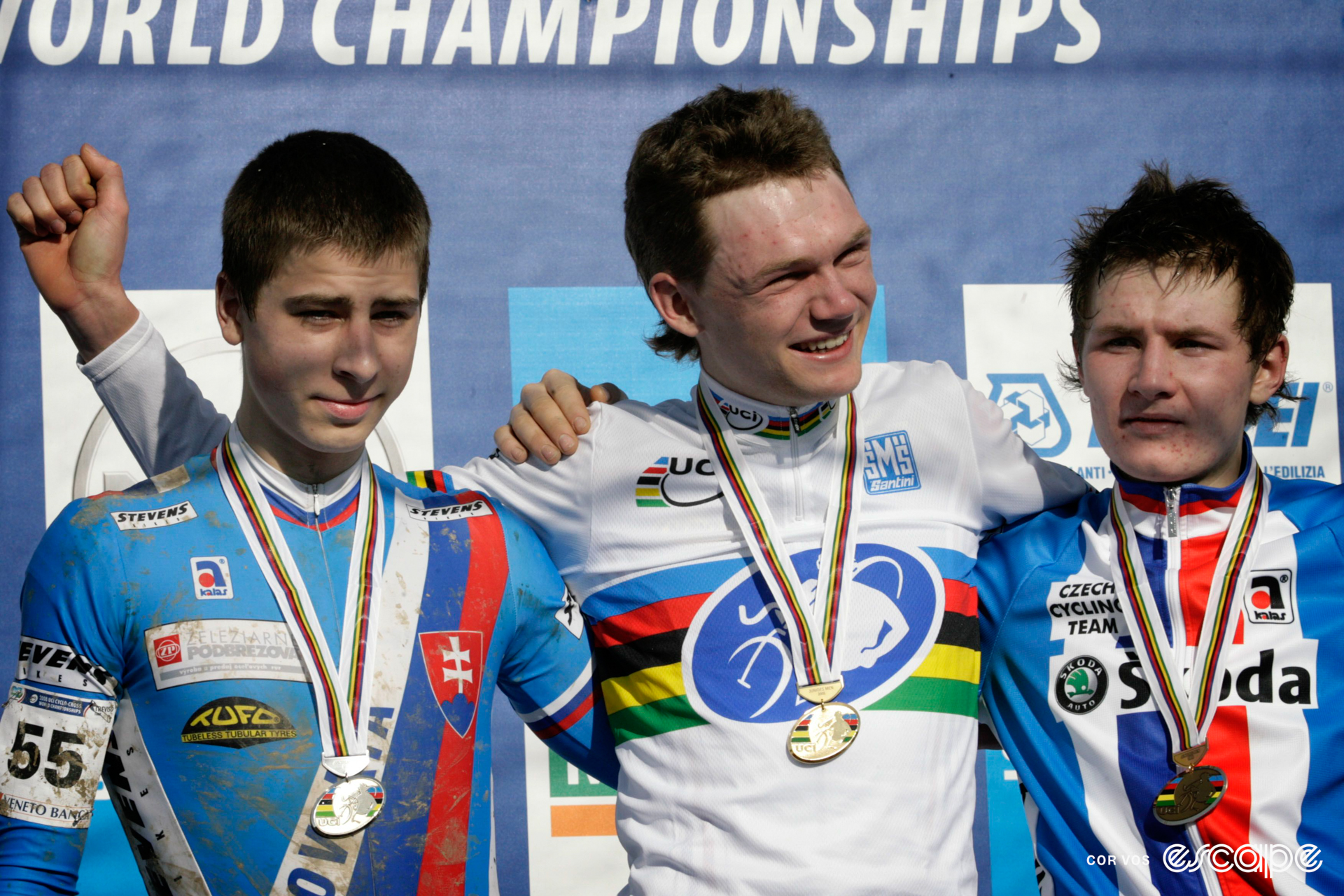 Peter Sagan stands on the podium at cyclocross Worlds, having won silver. Two cyclists stand to his left.