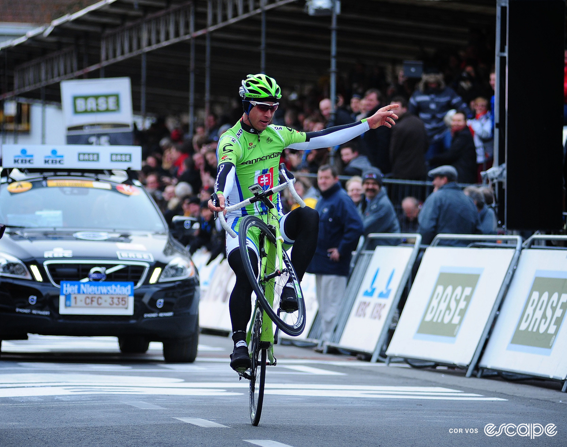 Peter Sagan celebrates winning the 2013 Gent-Wevelgem by doing a wheelie just past the finish line.