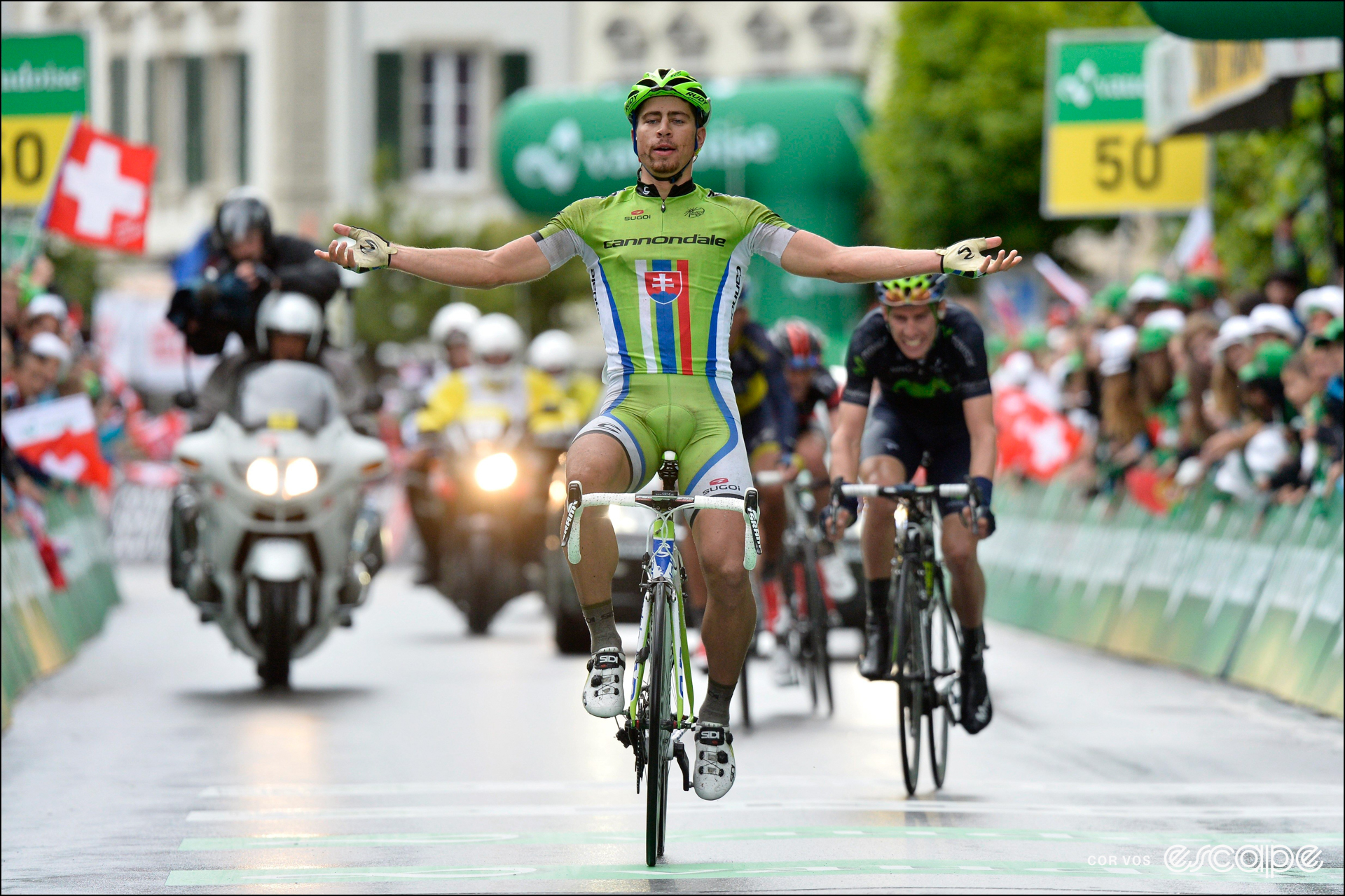 Peter Sagan celebrates winning a stage at the 2013 Tour de Suisse, with both arms horizontal out to his sides.