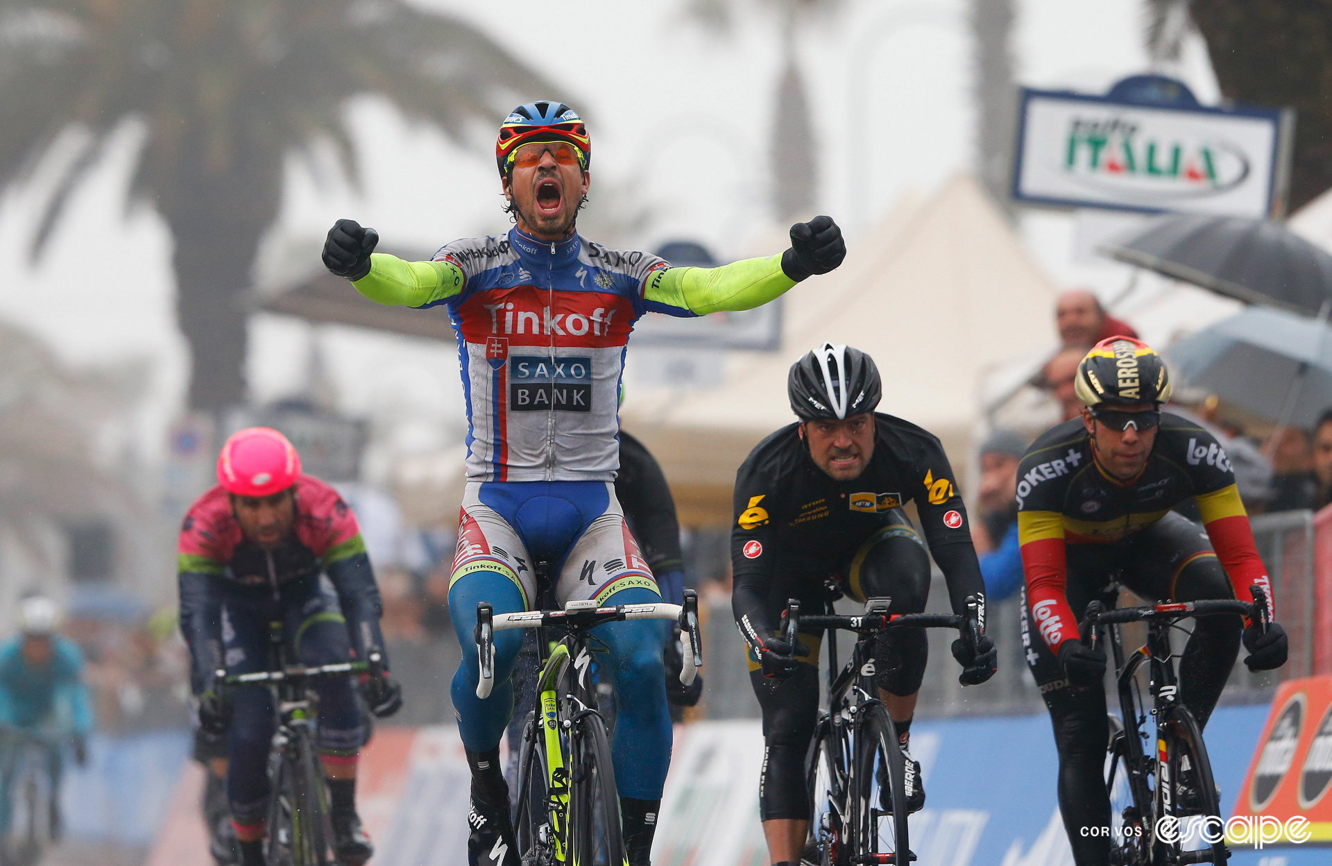 Peter Sagan celebrates winning a stage at the 2015 Tirreno-Adriatico, screaming in joy with arms in front of him, in the rain.