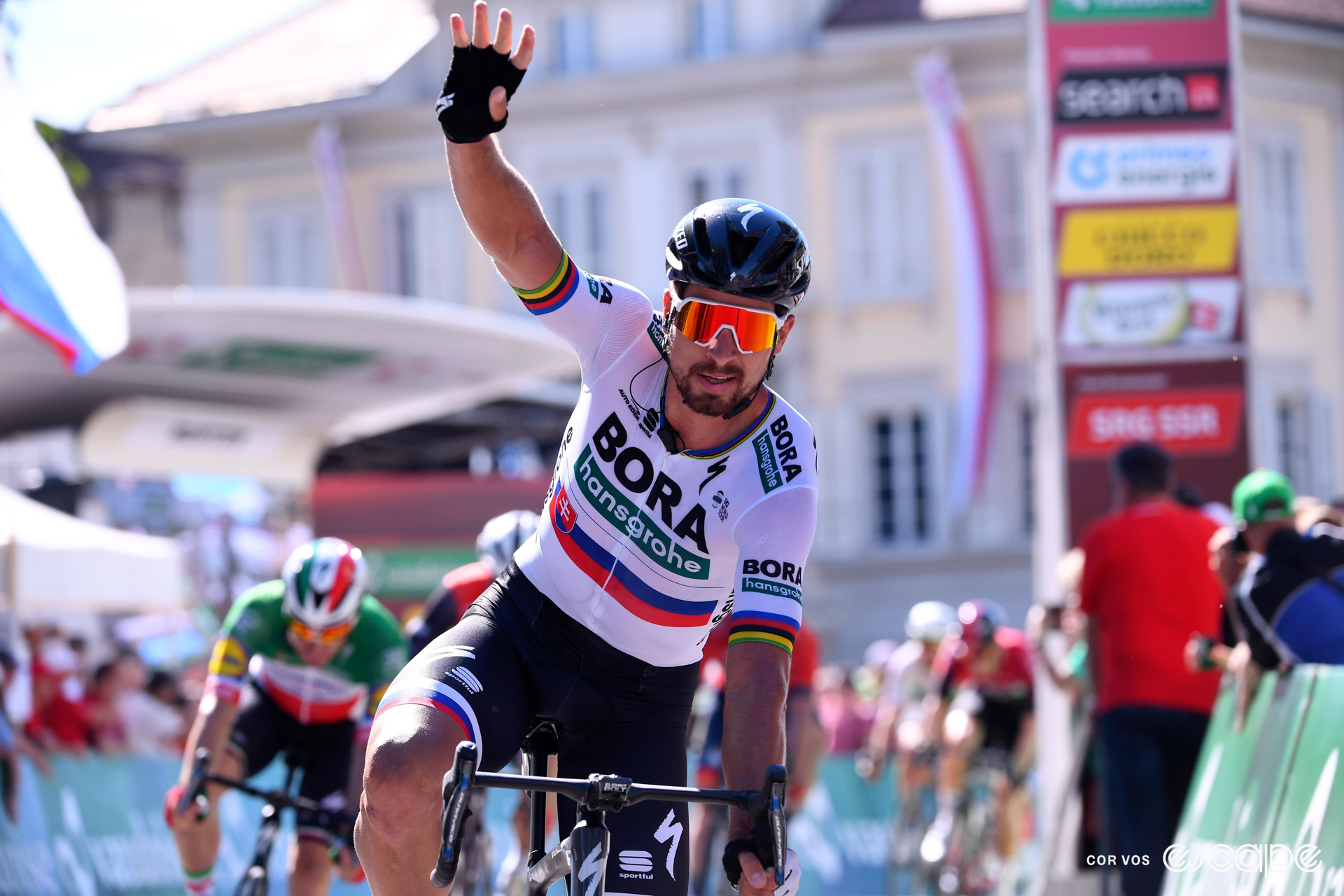 Peter Sagan celebrates winning a stage at the 2019 Tour de Suisse, with one arm in the air.