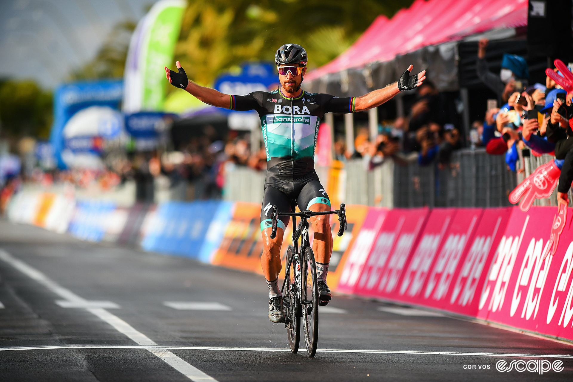 Peter Sagan celebrates winning a stage at the 2020 Giro d'Italia, with arms outstretched. He's the only rider in frame.
