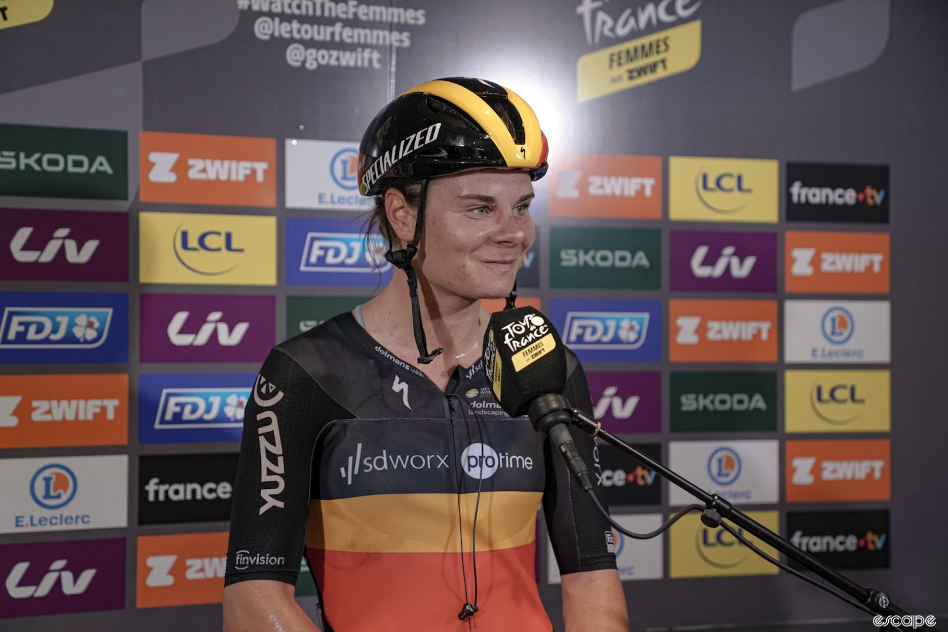 Lotte Kopecky smirks during the Tour de France Femmes stage 1 post-stage interview.