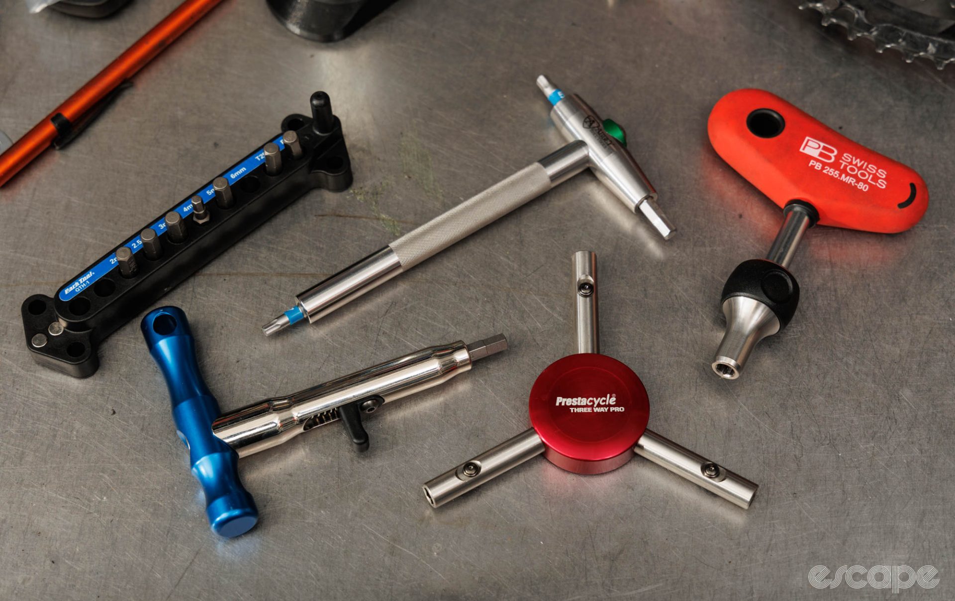 An assortment of bit-holding driver tools on a workbench. 