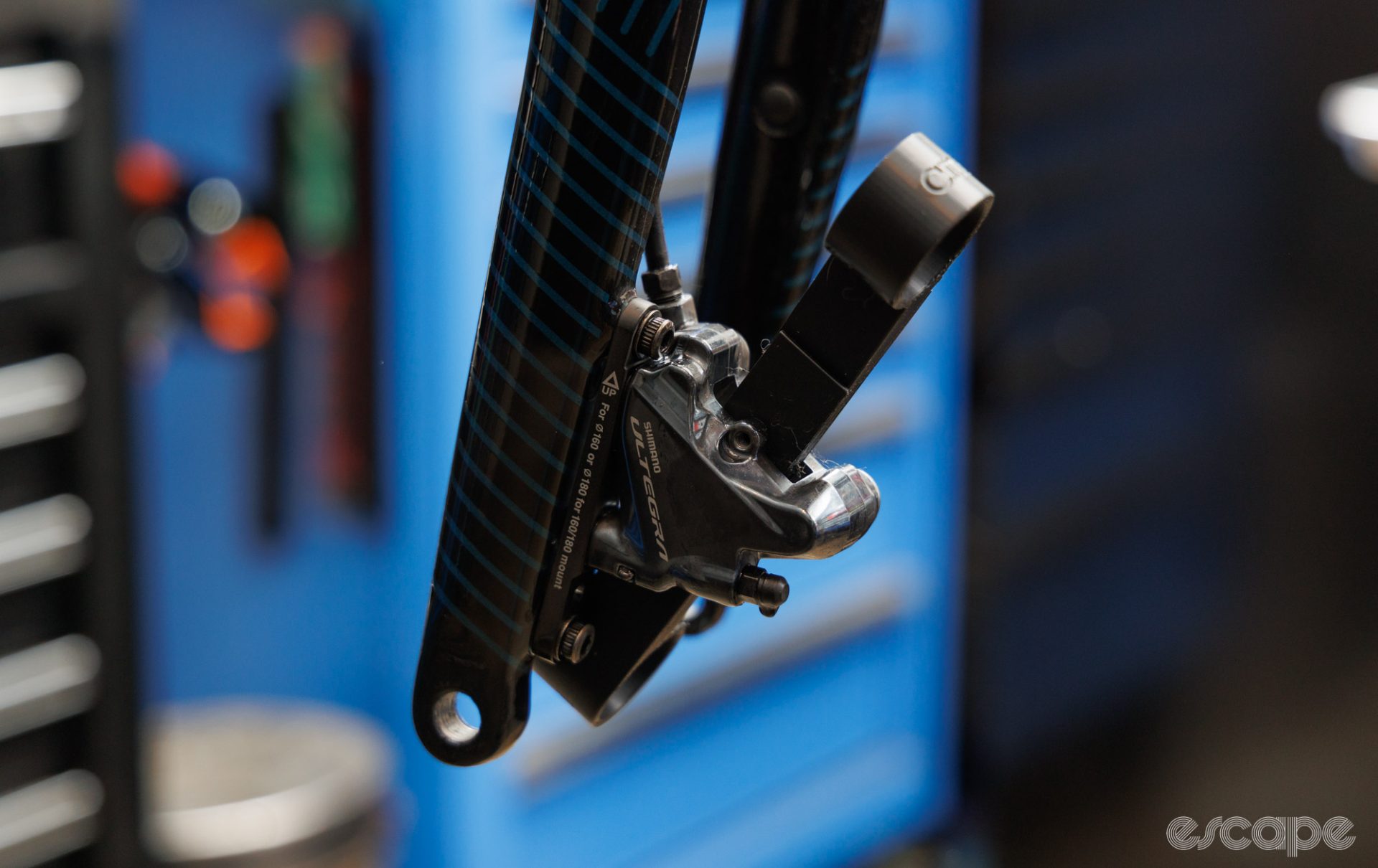 The CHM piston press tool placed within a Shimano road disc brake caliper. 