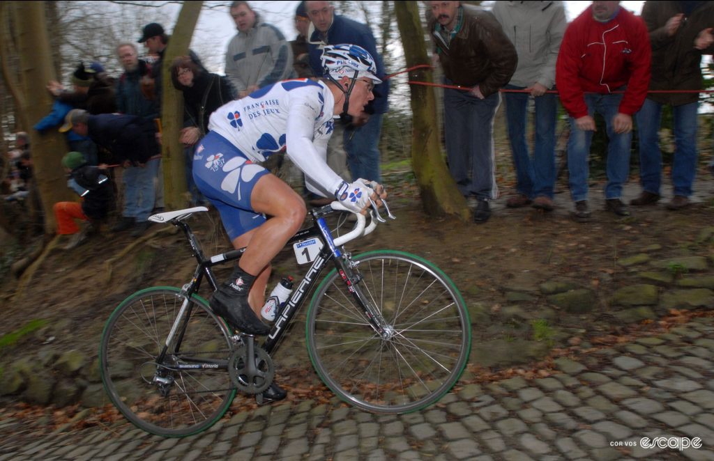 Gilbert rides up a cobbled climb out of the saddle.