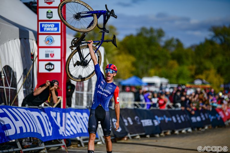 Thibau Nys thrusts his Trek cyclocross bike into the air after winning the opening round of the Cyclocross World Cup.