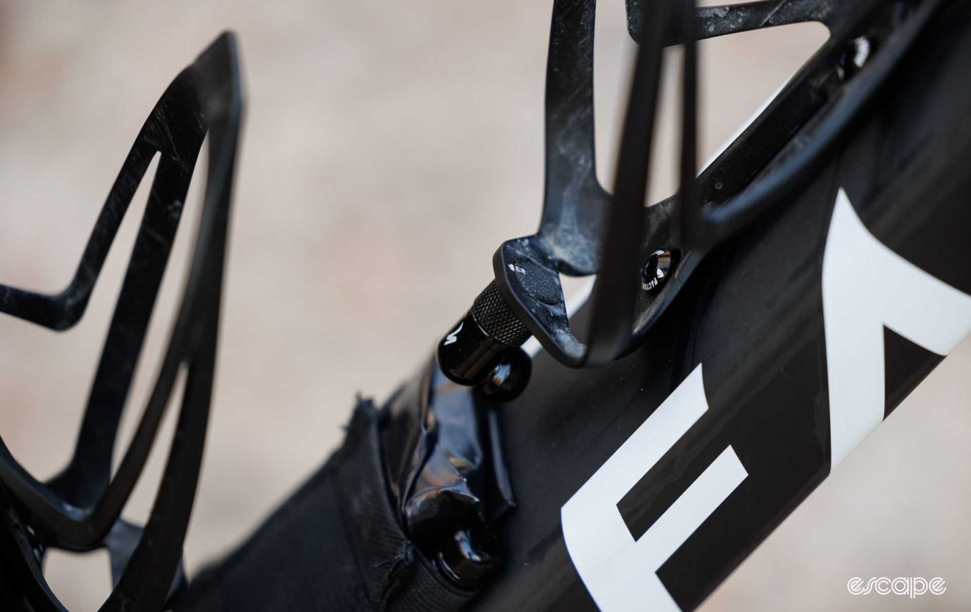 A custom 3D-printed accessory used to mount a Co2 inflator head to a bottle cage. 
