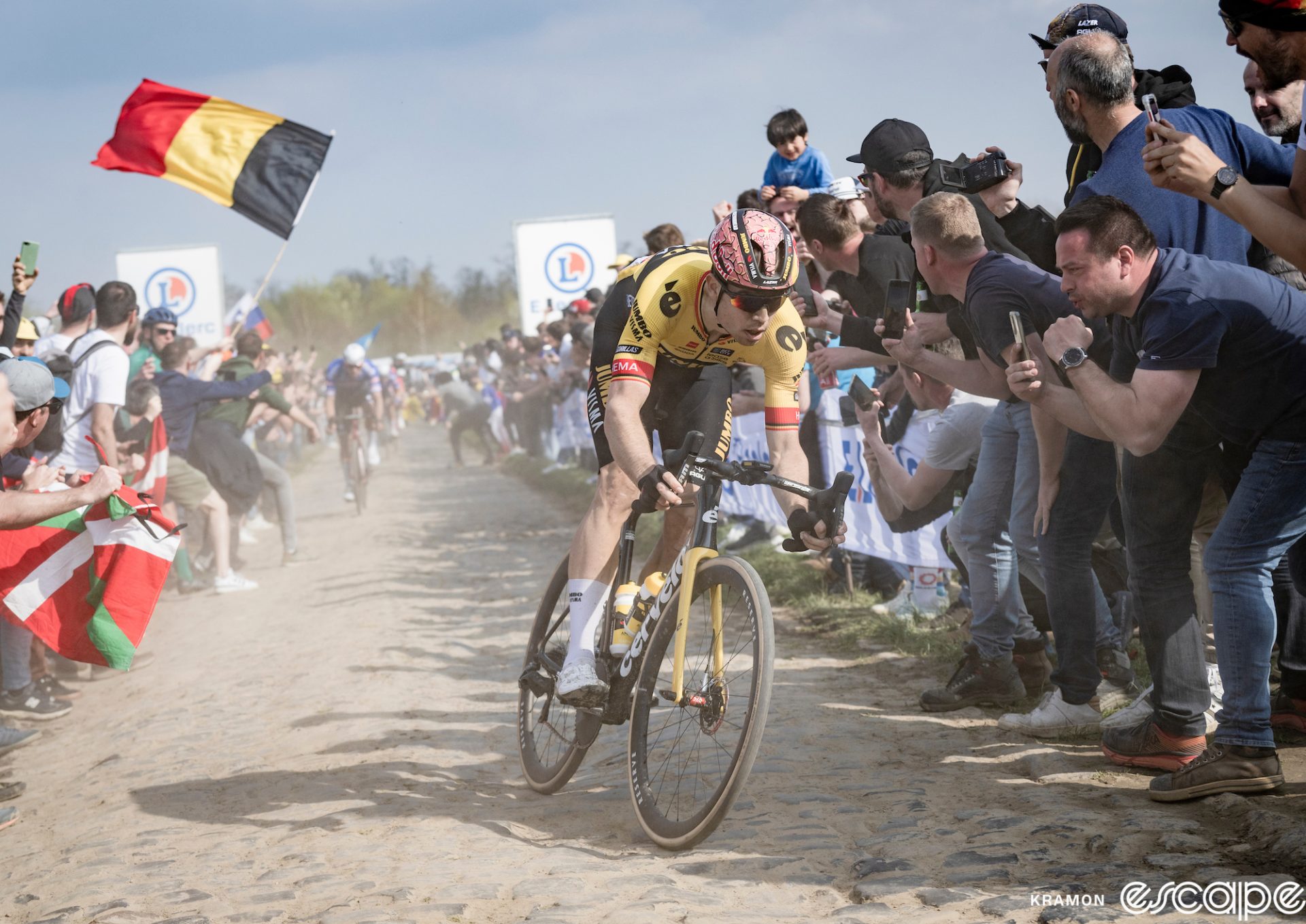 Wout van Aert attacks on the cobbles at the Carrefour de l'Arbre in the 2023 Paris-Roubaix. His chief rival, Mathieu van der Poel, is momentarily distanced behind.