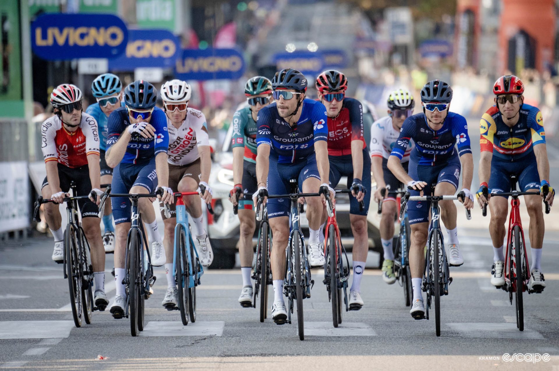 Thibaut Pinot crosses the line flanked by teammates. 
