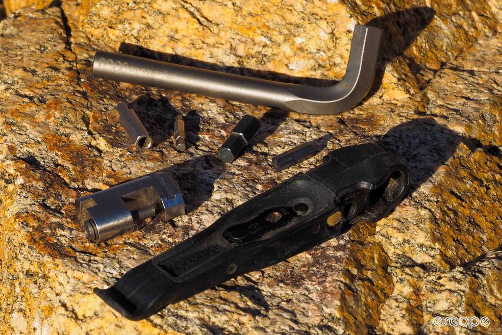 Daysaver Essential8 and CoWorking5 multi-tools spread out on rock