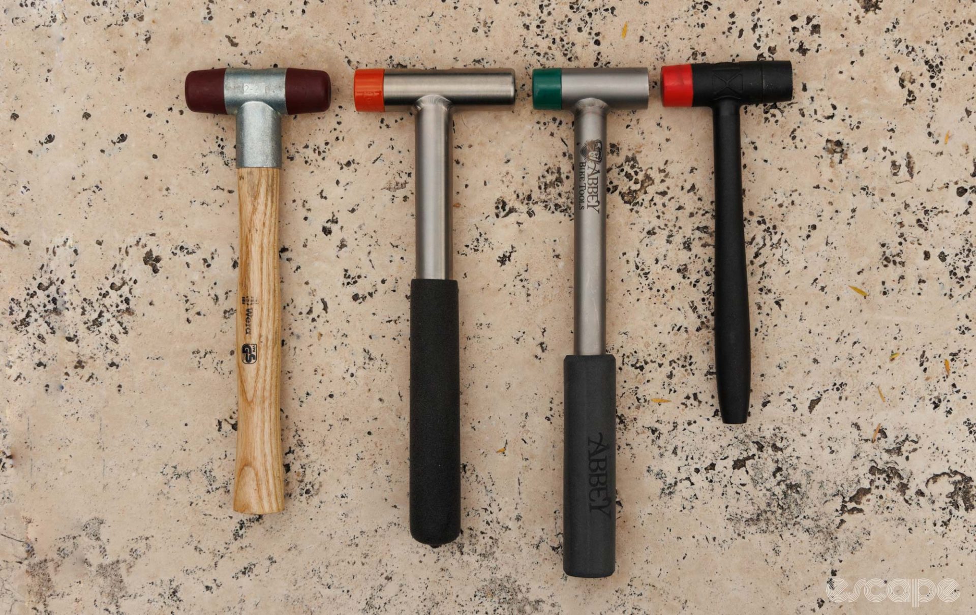 Four small hammers laid out next to each other. 