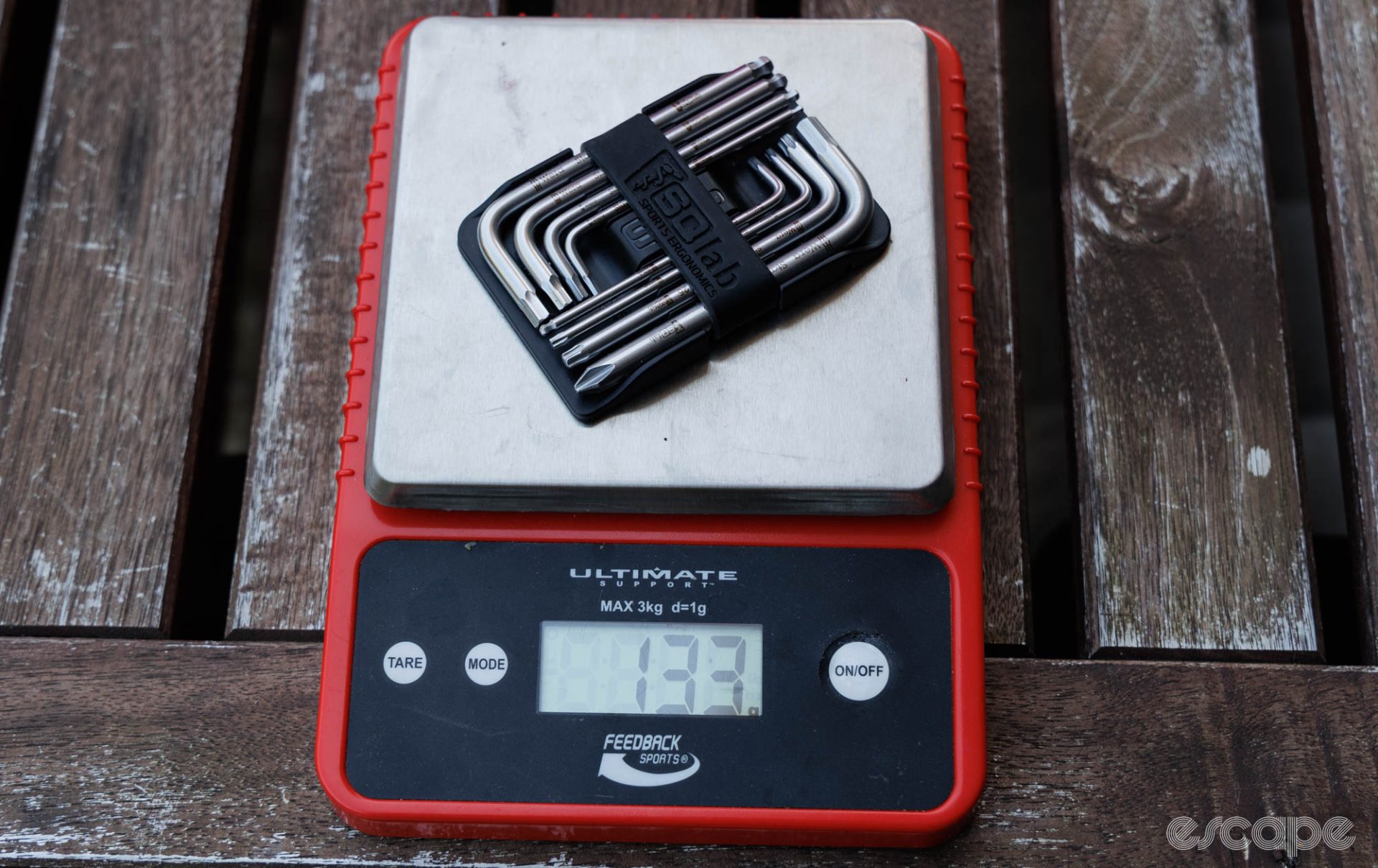 The SQLab tool set on a scale reading 133 grams. 