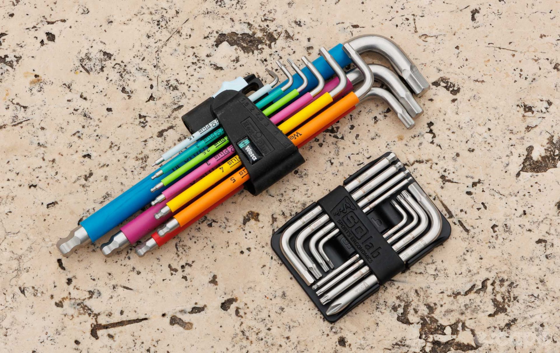 The SQLabs tool set next to a full length rainbow coloured hex key set from Wera. Both are manufactured in the same place and of the same stainless material. 
