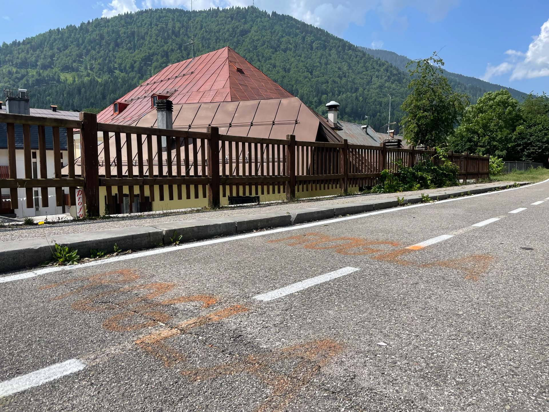 Faded paint on a hillside road reads "Rogla".