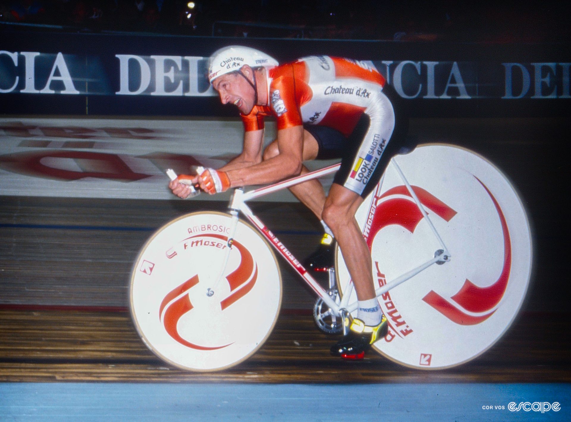 Francesco Moser on a bike with an enormously oversized rear wheel, a much smaller front one, a deep tuck and exaggerated aero position. 