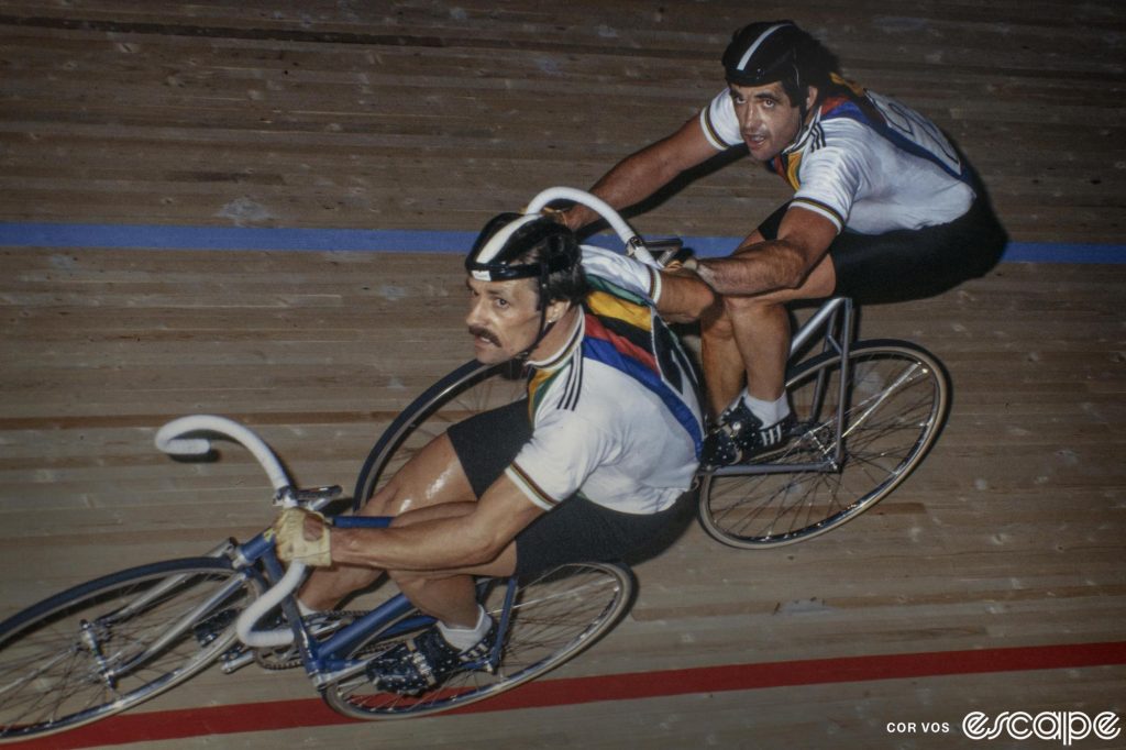 Danny Clark exchanges a hand sling with a teammate at an old track race.