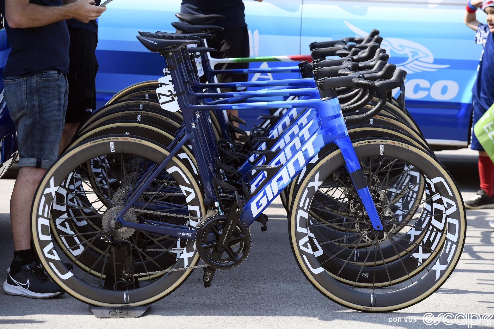 Giant bicycles are lined up outside the Jayco-AlUla team bus.