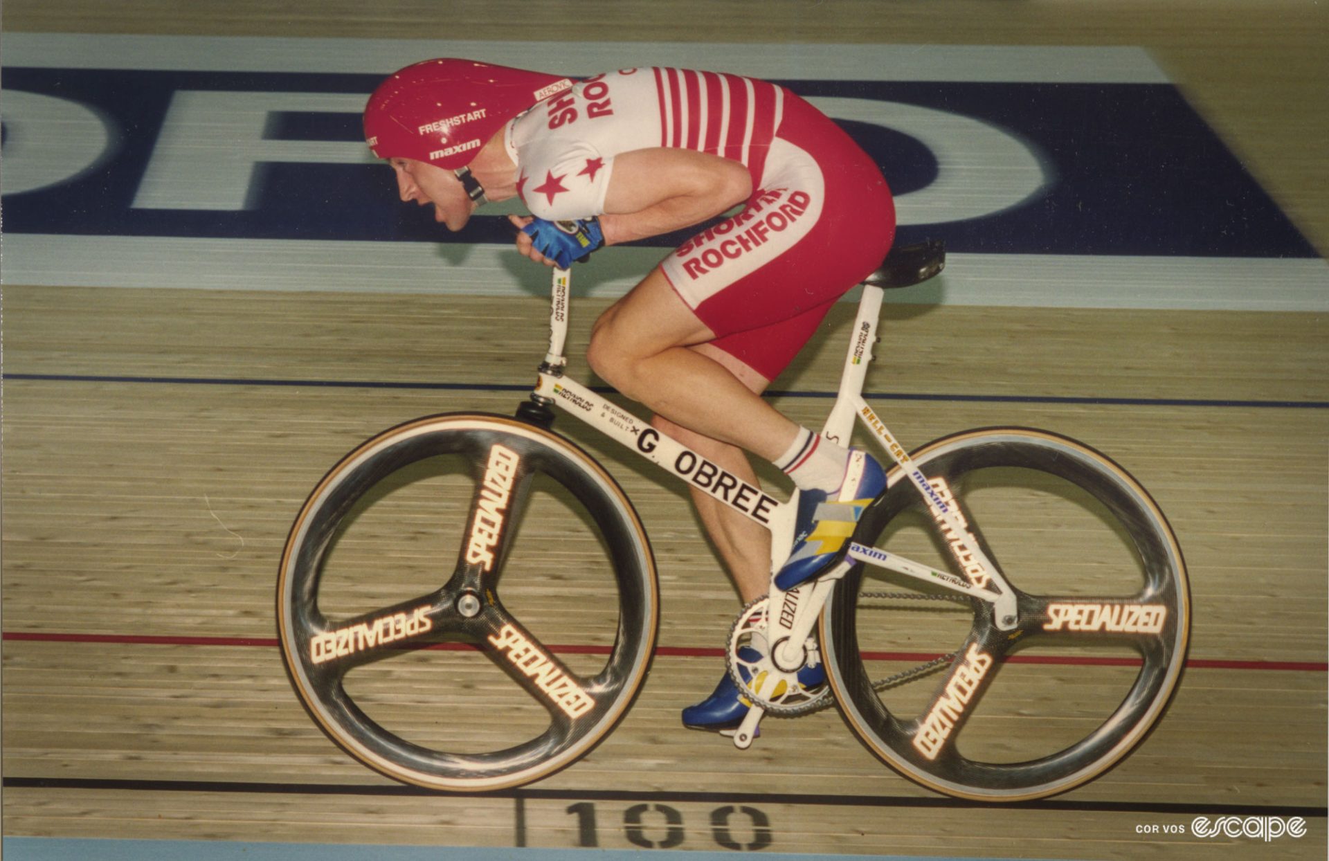 Graeme Obree on his home-made Old Faithful, in an extreme tuck position, arms in tight by his sides. 