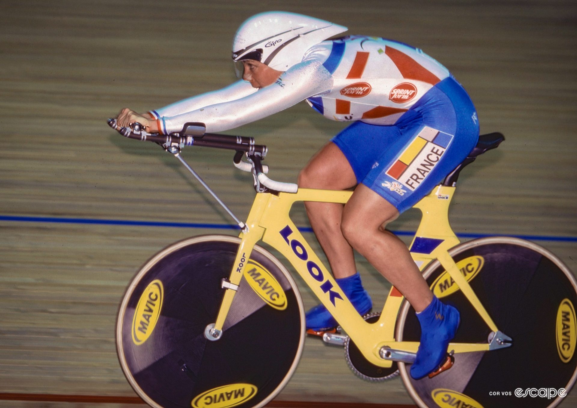 Marion Clignet on a yellow Look track bike, also using the superman pose. 
