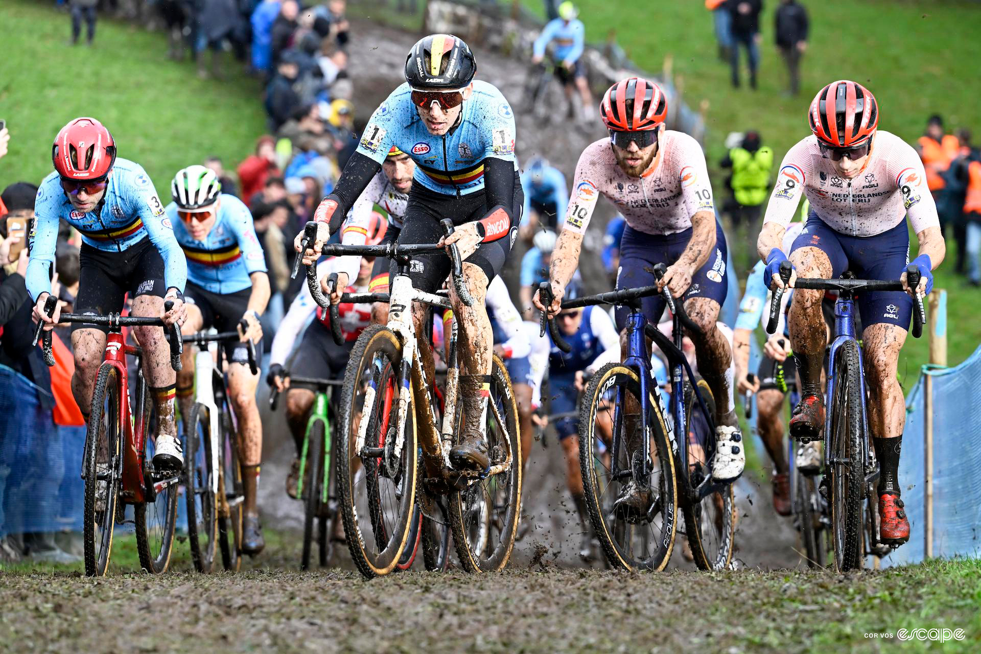 The elite men's bunch rides four abreast through the first turns of the european cyclocross champs course.