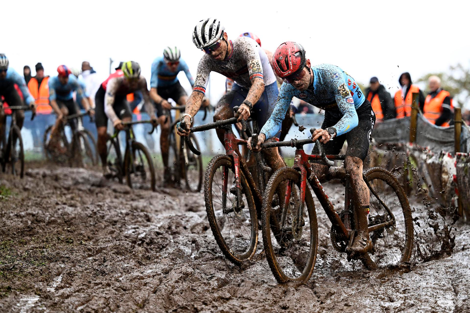 Britain's Cameron Mason and Belgian Eli Iserbyt turn through an incredibly muddy corner during the 2023 CX European Champs.